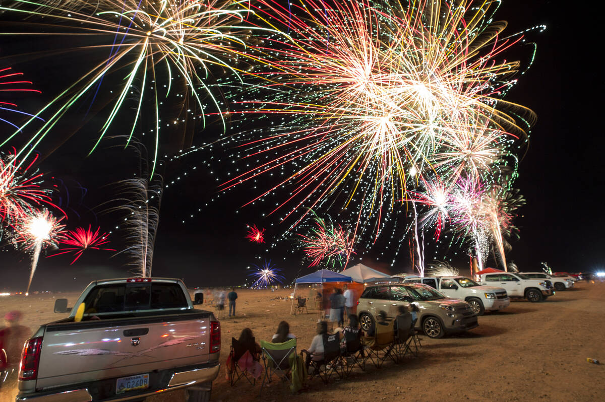 Fireworks explode from a launchpad behind the Moapa Paiute Travel Plaza firework store during F ...