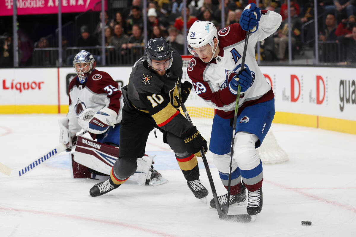 Vegas Golden Knights center Nicolas Roy (10) fights for the puck against Colorado Avalanche cen ...