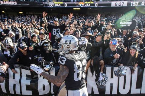 Oakland Raiders tight end Darren Waller (83) fires up the crowd in the "Black Hole" at the Oakl ...