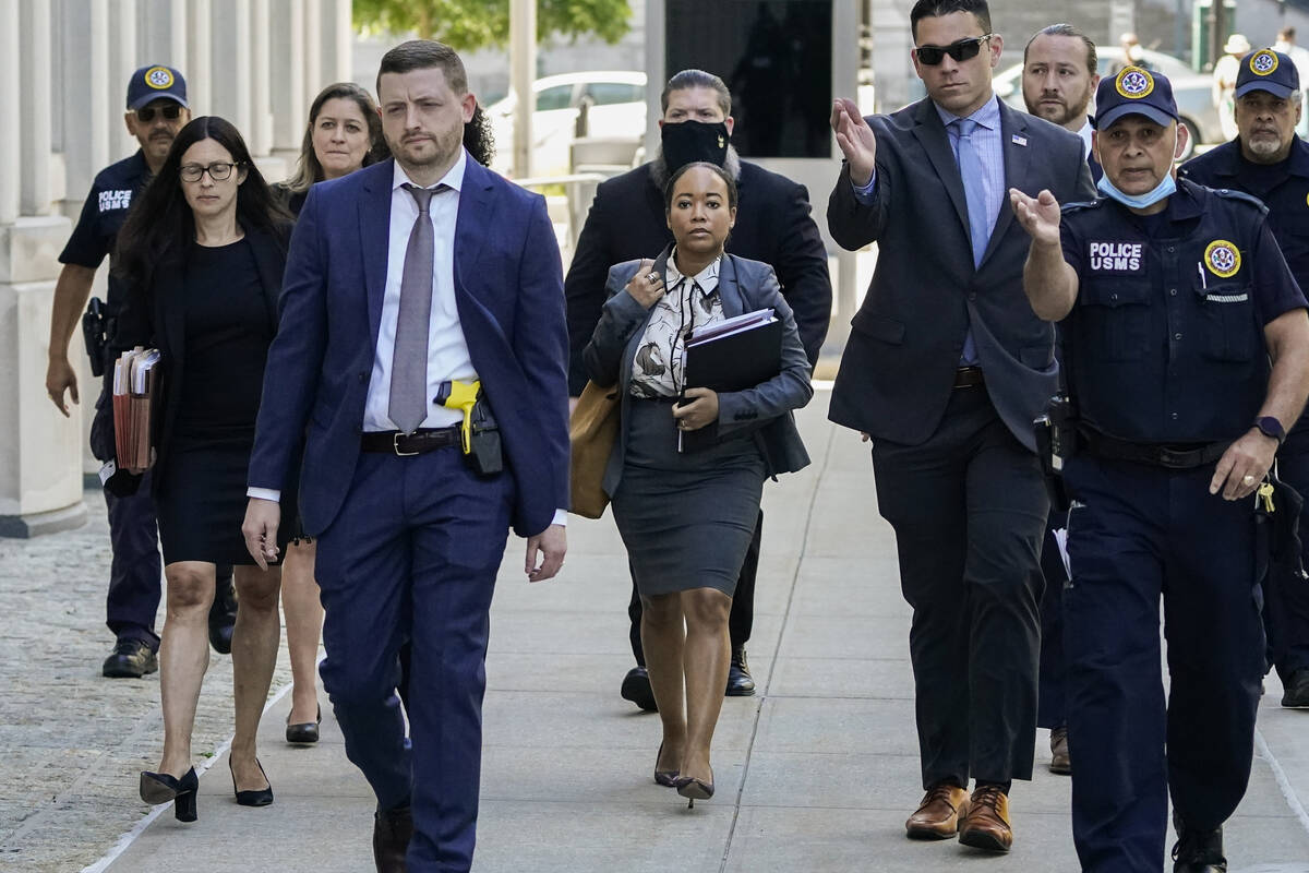 The prosecution team in the trial against R. Kelly is escorted by federal agents as they arrive ...
