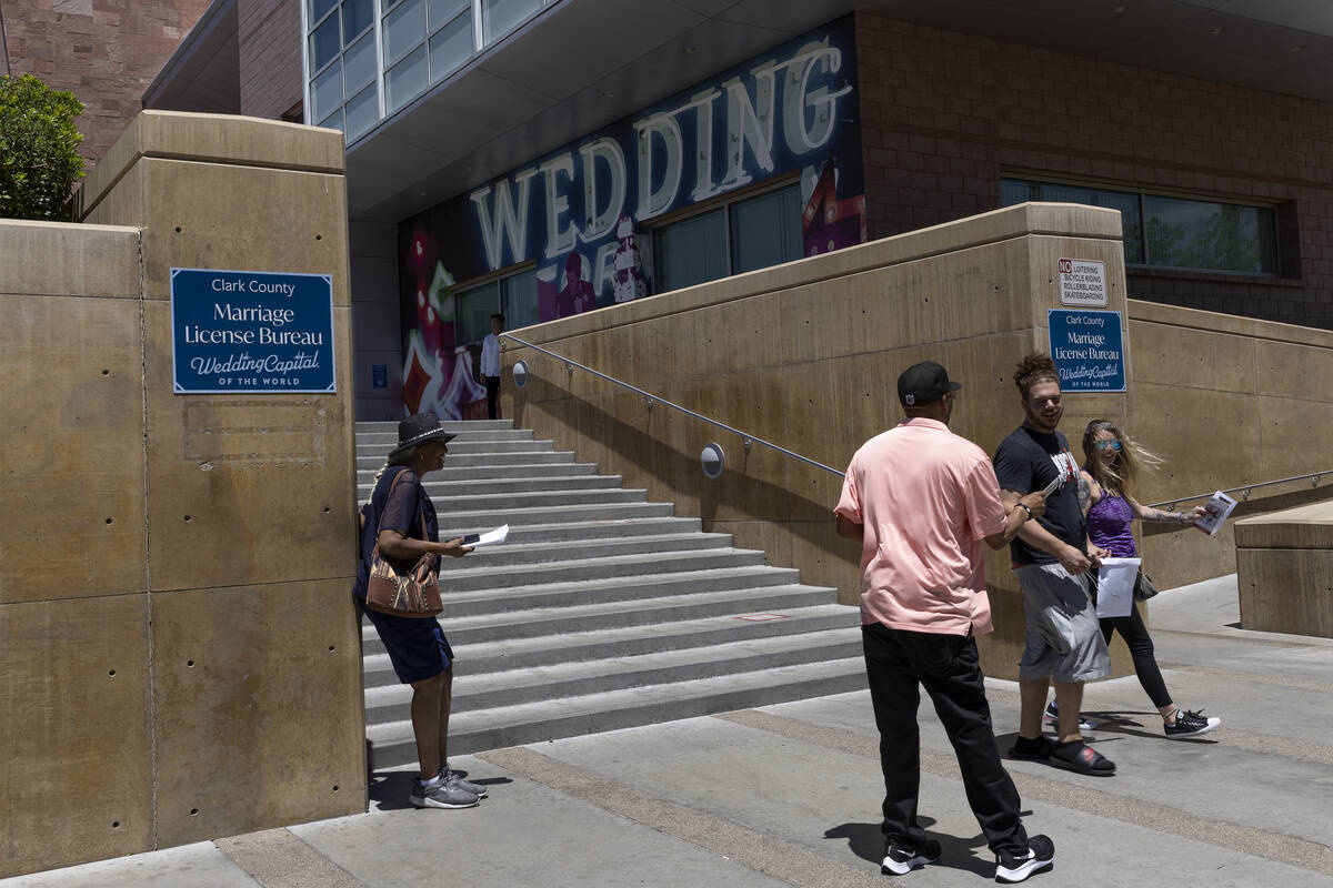 Newlyweds leave the Clark County Marriage License Bureau on Thursday, June 30, 2022, in downtow ...