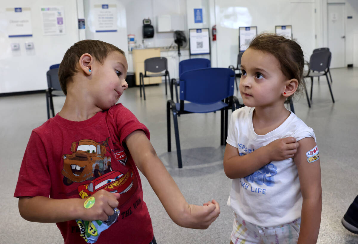 FILE - Three-year-old twins Luca, left, and Quincy Yacoub show off their Band-Aids after gettin ...