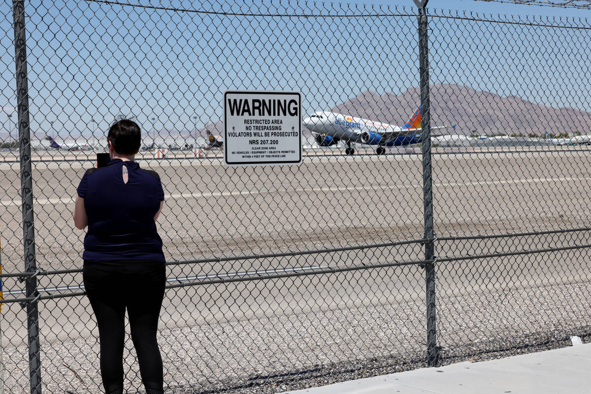 People check out planes at the Harry Reid International Airport viewing area on Sunset Road in ...