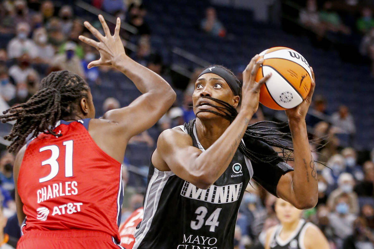 Minnesota Lynx center Sylvia Fowles (34) shoots over Washington Mystics center Tina Charles (31 ...