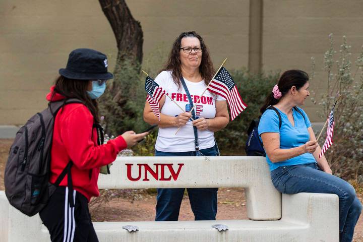 FILE - A UNLV student walks past protesters, including Susie K. of Las Vegas, right, as they pr ...