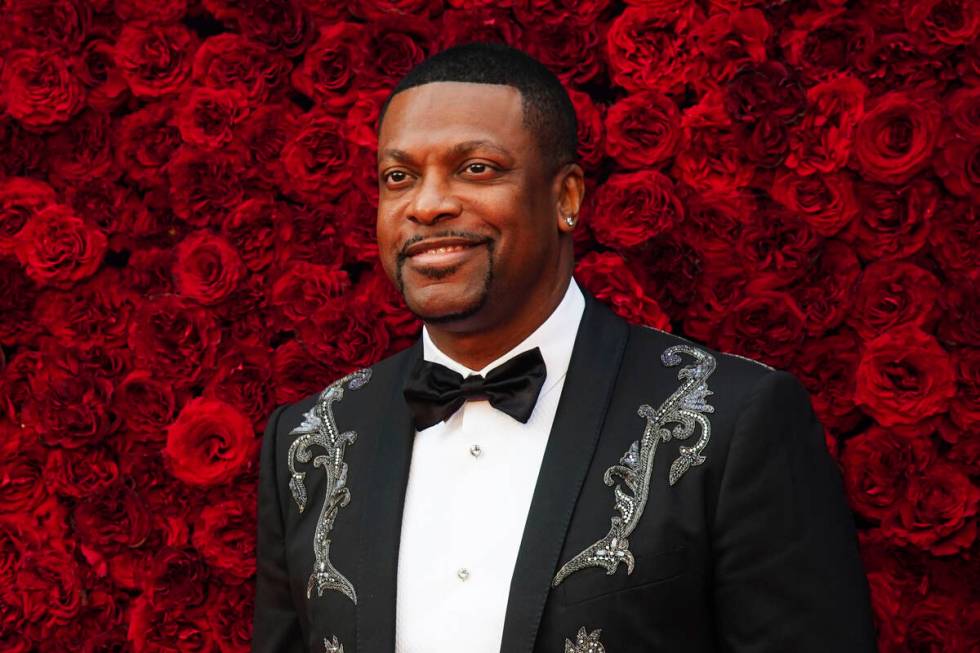 Chris Tucker poses for a photo on the red carpet at the grand opening of Tyler Perry Studios on ...