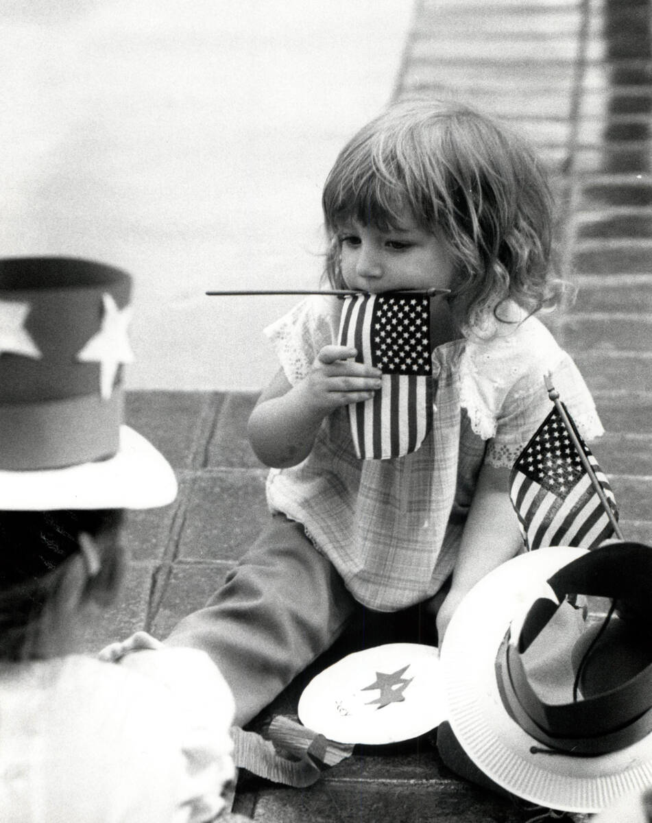 This July 4, 1982, file photo shows a girl holding a flag in Boulder City. (Gary Thompson/Las V ...