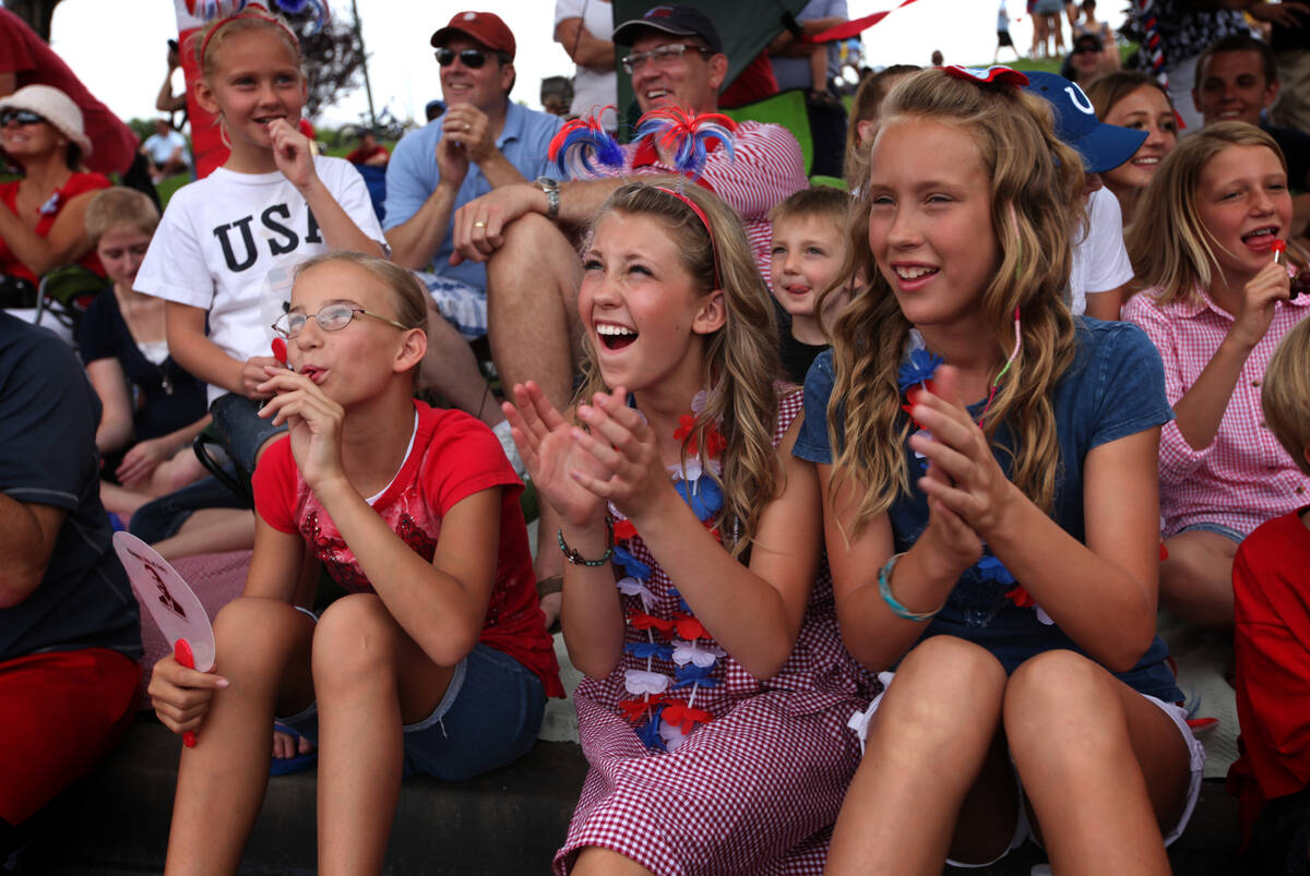 In this July 4, 2011, file photo, Megan Gneiting, 13, center, and Heather Gneiting, 11, right, ...