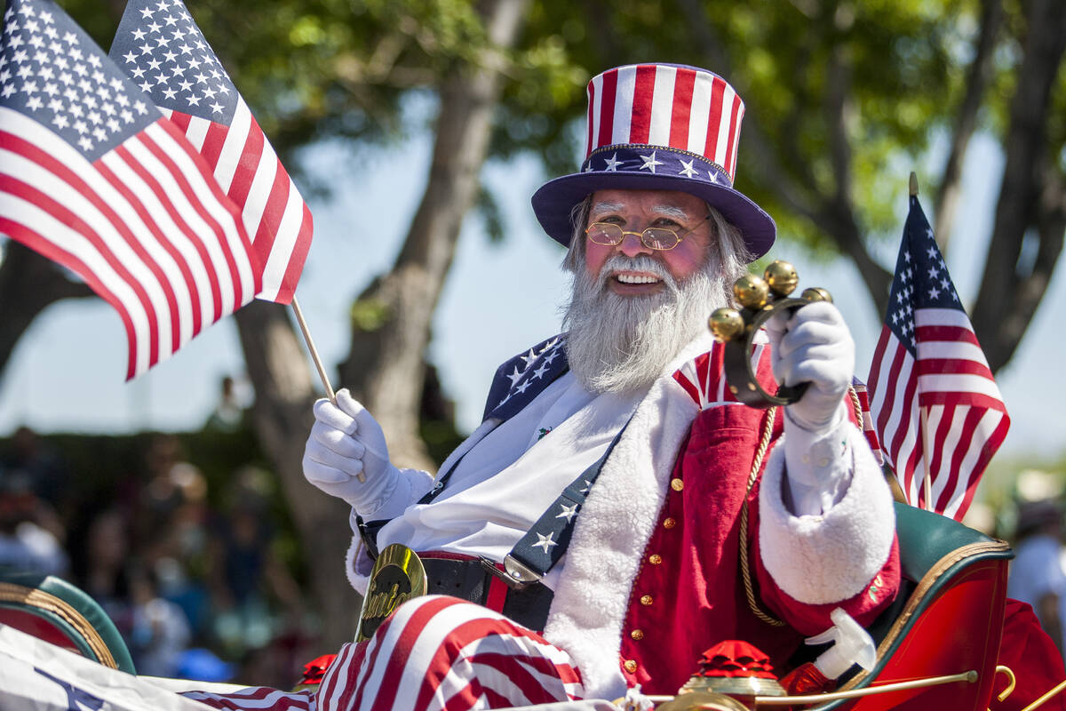 In this July 4, 2017, file photo, a patriotic Santa Claus smiles out to the crowds during the S ...