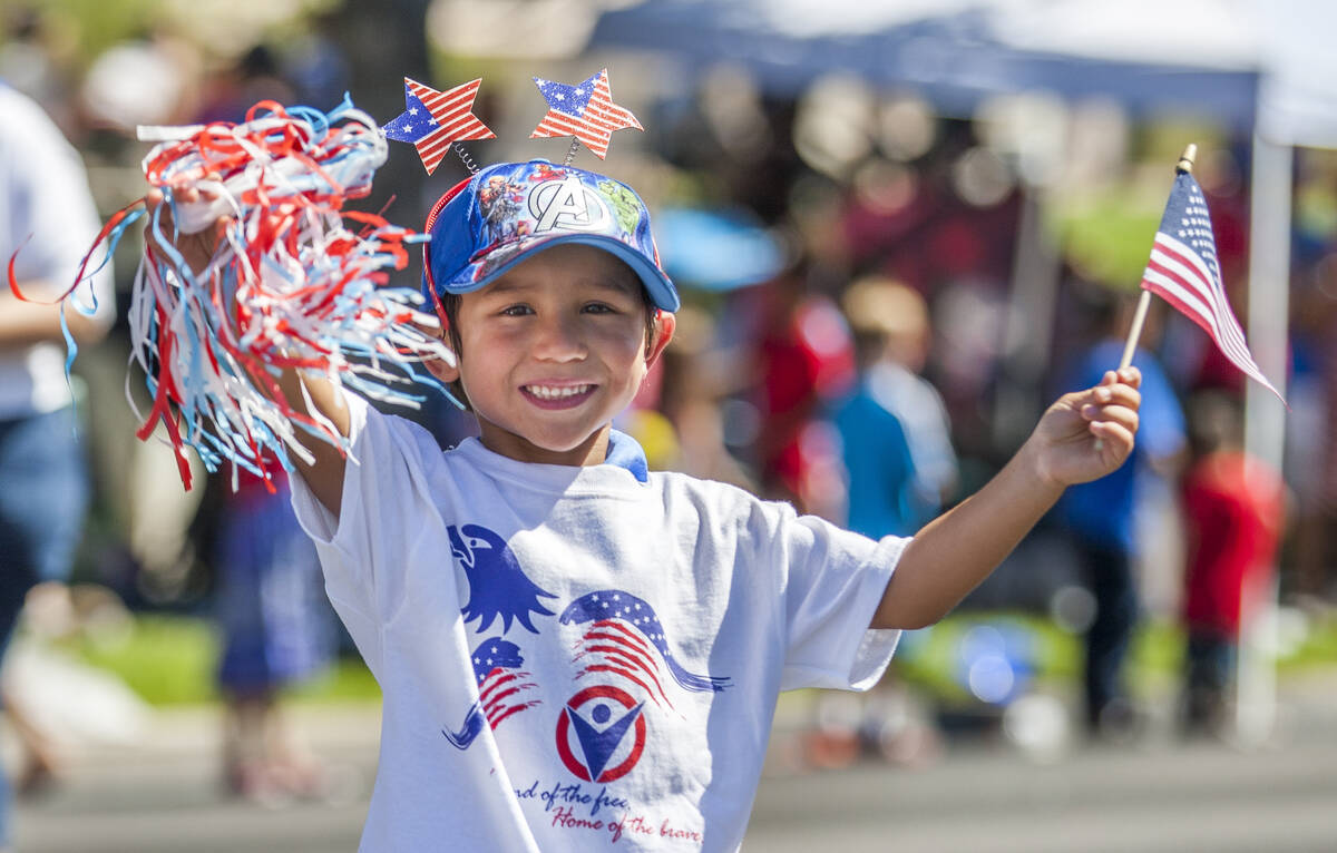 In this July 4, 2017, file photo, a young paradegoer waves to crowds as he marches in the parad ...