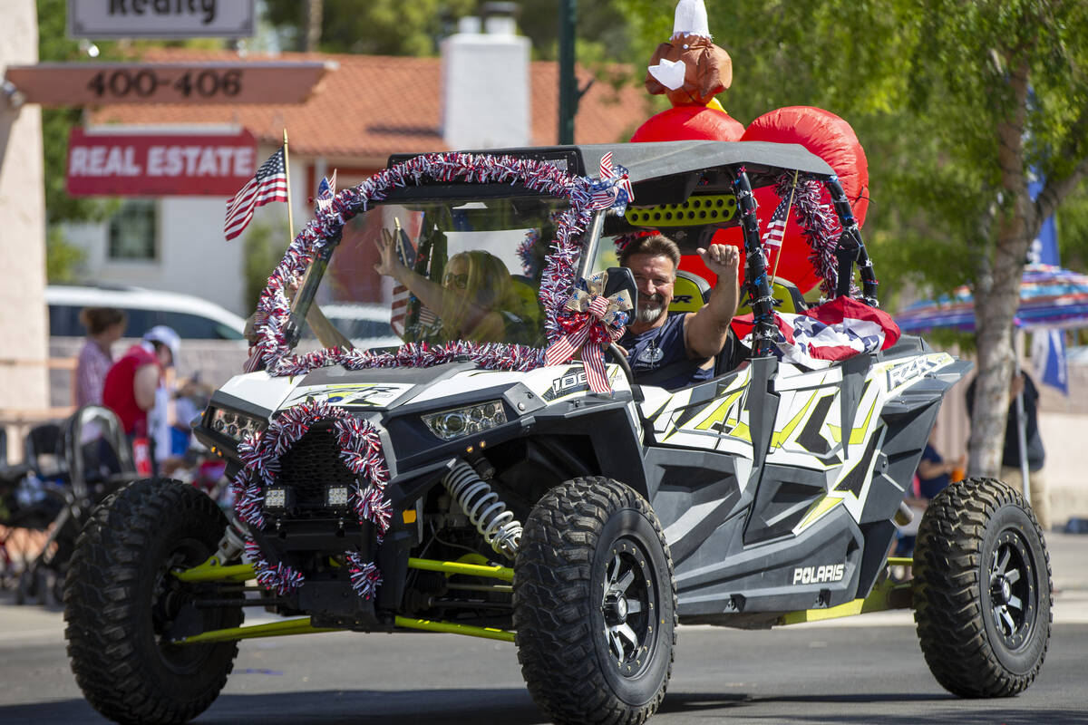 In this July 3, 2021, file photo, a dune buggy passes through the parade route during the two-d ...