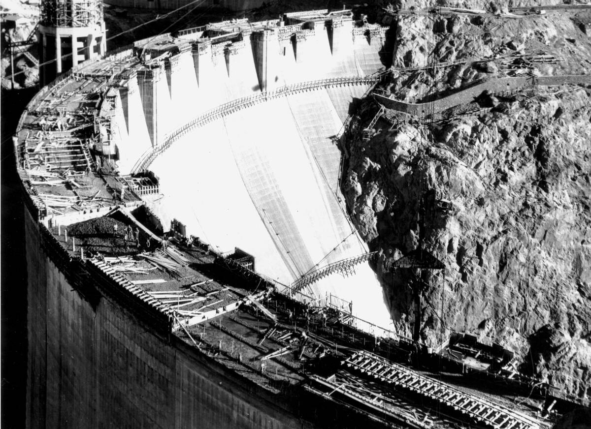 More than 700 feet over the Colorado River bed, workers put the finishing touches on the Hoover ...