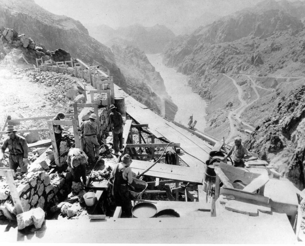 Construction continues Jan. 9, 1932 as workers construct the retaining wall that gives support ...