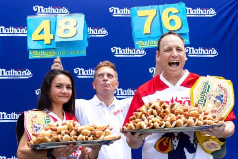 Competitive eaters Michelle Lesco and Joey Chestnut pose for photos with their record number of ...