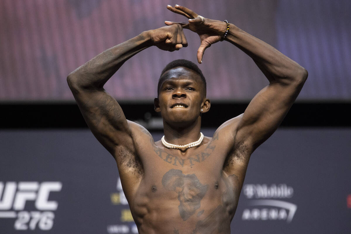Israel Adesanya poses during an UFC 276 weigh-in event at T-Mobile Arena in Las Vegas, Friday, ...
