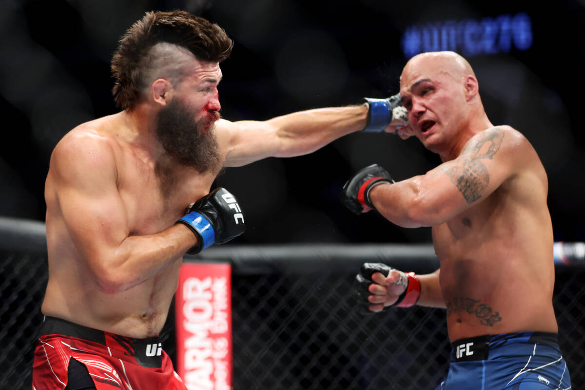 Bryan Barberena, left, lands a punch against Robbie Lawler during the second round in a welterw ...