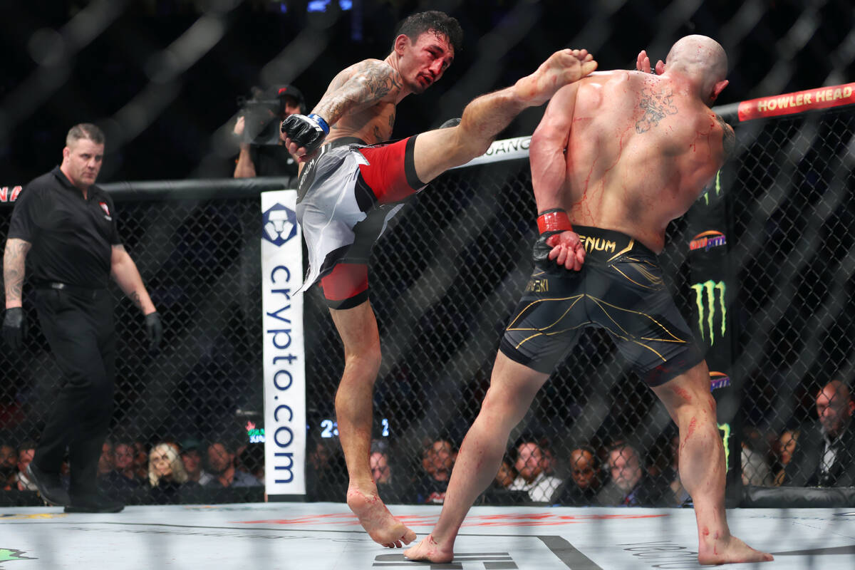 Alexander Volkanovski, right, defends a kick from Max Holloway in the fifth round of a featherw ...