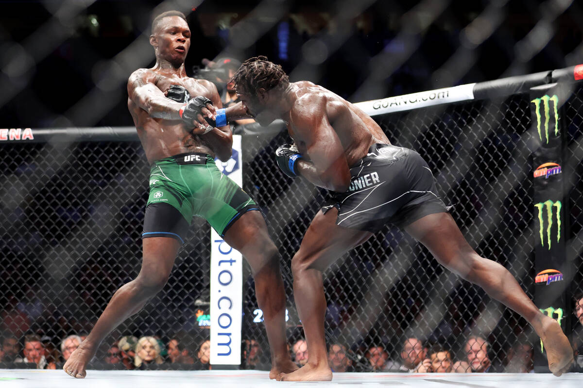 Israel Adesanya, left, and Jared Cannonier, battles during the fourth round of a middleweight f ...