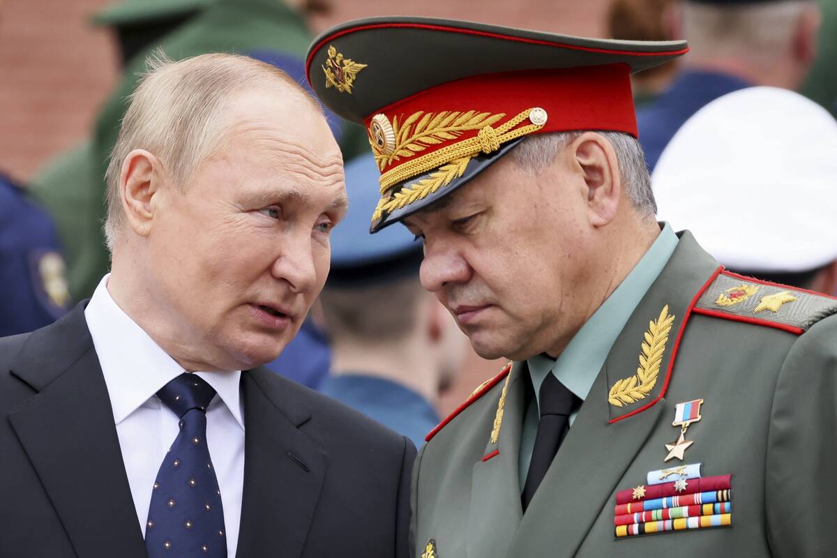 FILE - Russian President Vladimir Putin speaks with Russian Defence Minister Sergei Shoigu duri ...