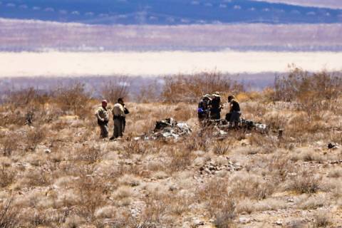 Investigators work the scene where a small aircraft crashed, killing its pilot, near Boulder Ci ...