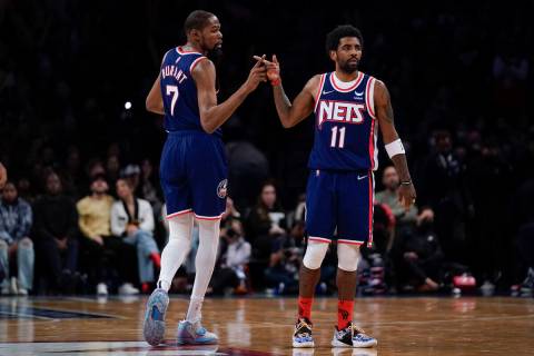 Brooklyn Nets' Kyrie Irving, right, and Kevin Durant celebrate after a basket during the second ...