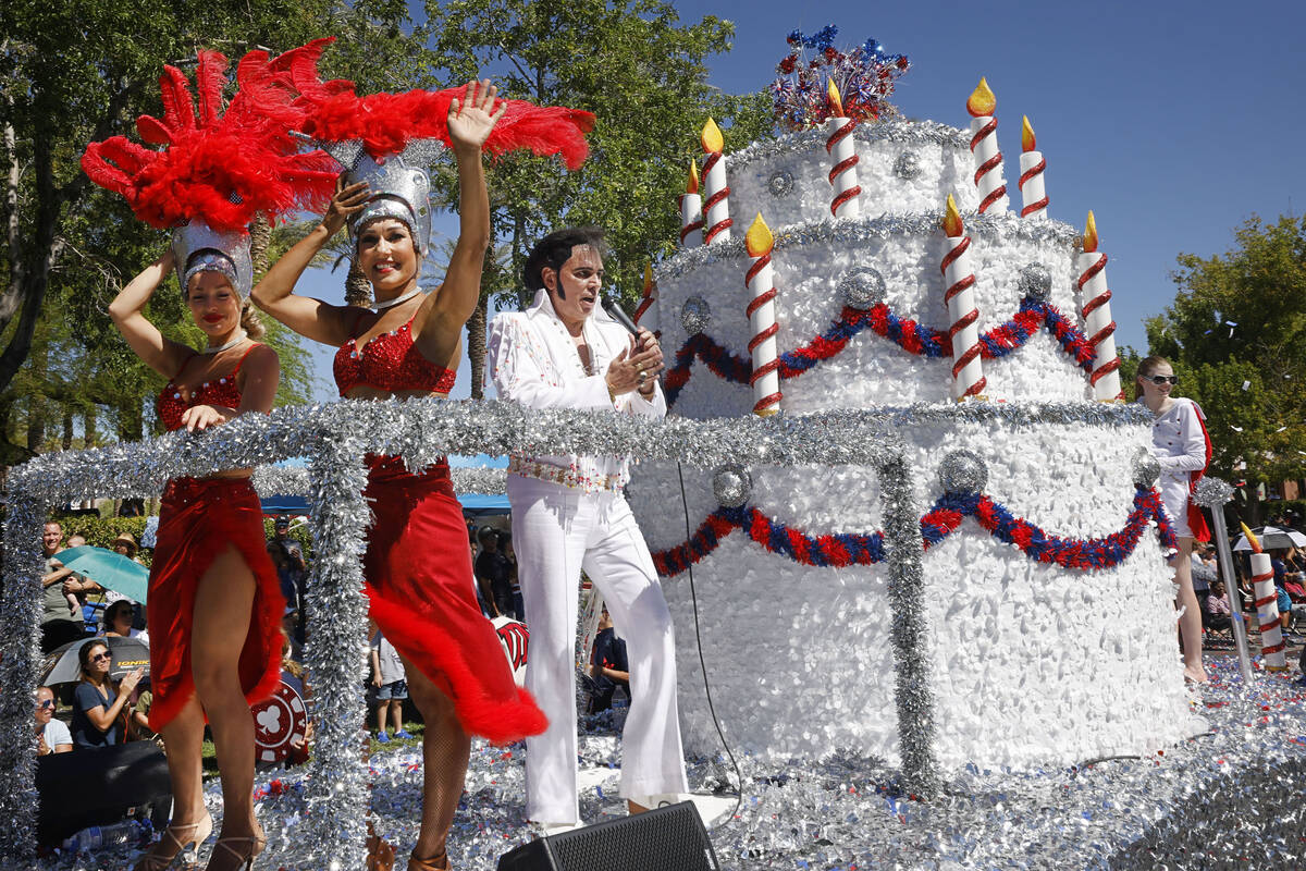 An Elvis impersonator and showgirls perform on the float, “A Very Vegas Birthday,” during t ...
