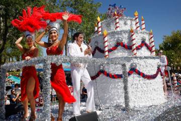 An Elvis impersonator and showgirls perform on the float, “A Very Vegas Birthday,&#x201d ...