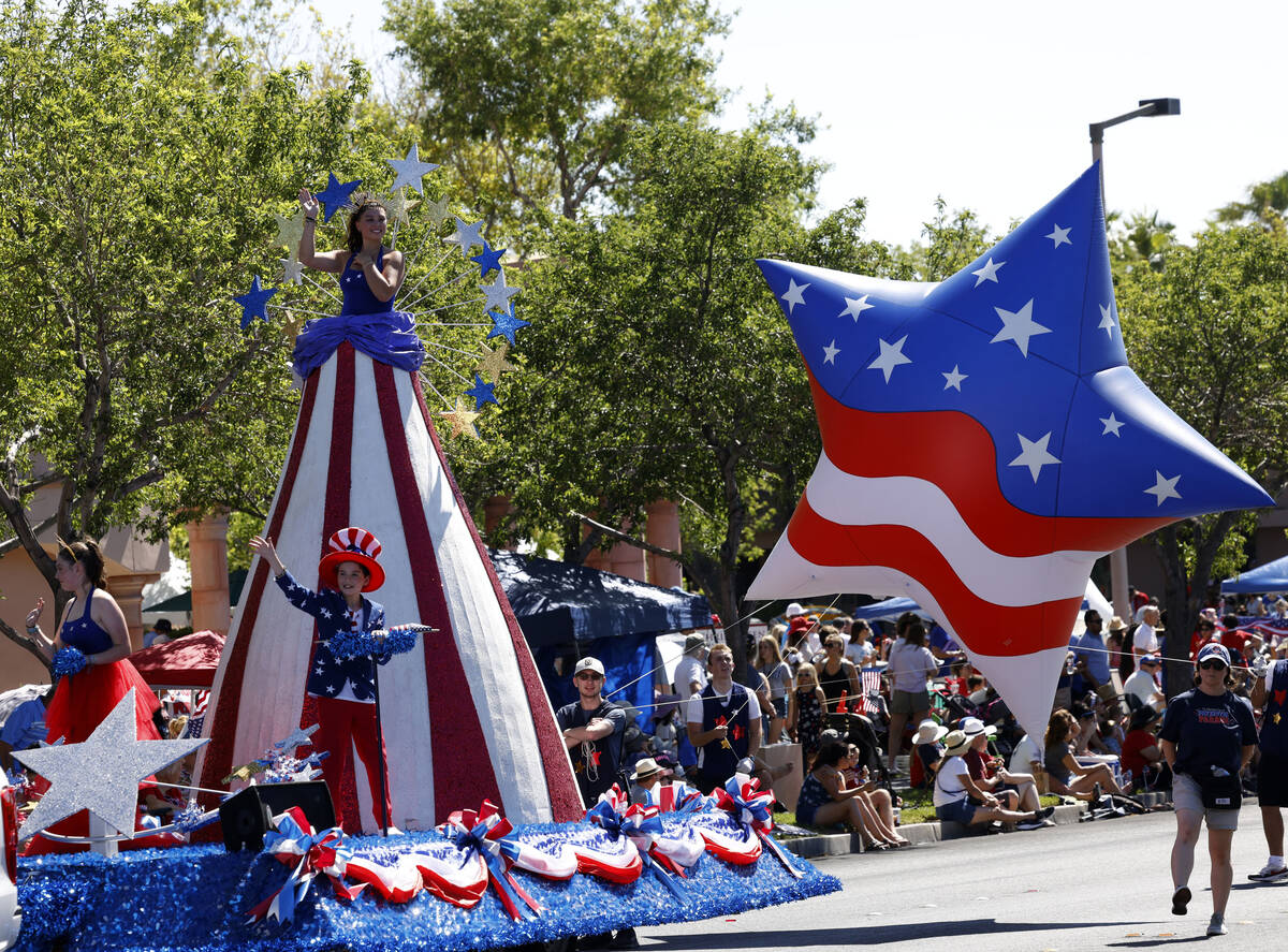 A 15-foot Miss Stars and Stripes waves on “America Standing Tall” float during th ...