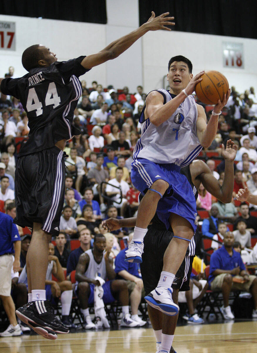 Jeremy Lin of the Mavericks goes up for a shot against JP Prince of the Wizards during their ga ...