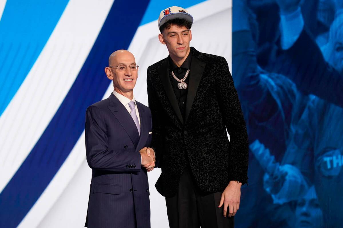 Chet Holmgren, right, poses for photos with NBA Commissioner Adam Silver after being selected s ...