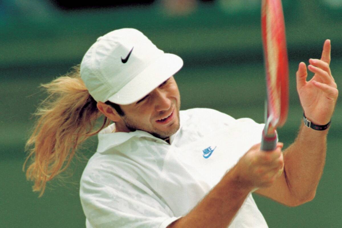 Andre Agassi swings into a return to Goran Ivanisevic, during the men's singles final on the Ce ...