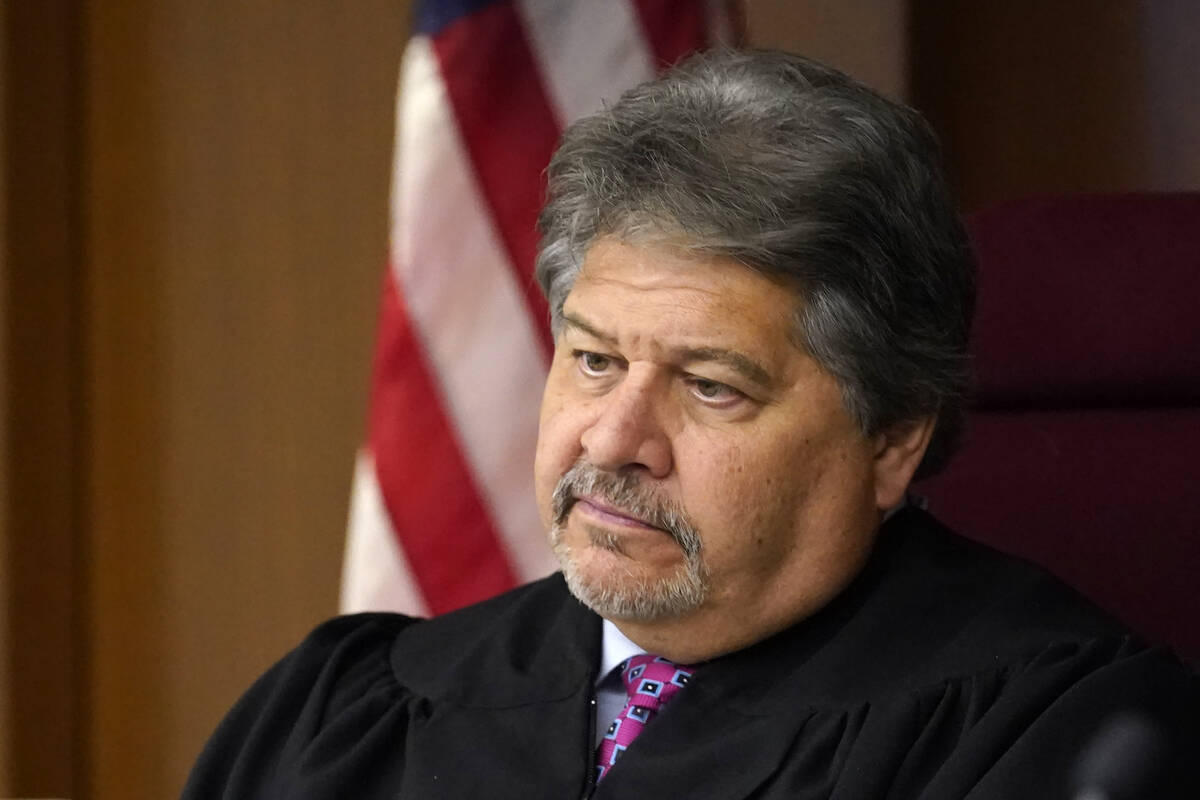 Lake County Judge Theodore Potkonjak looks at a video screen as he presides over the initial ap ...