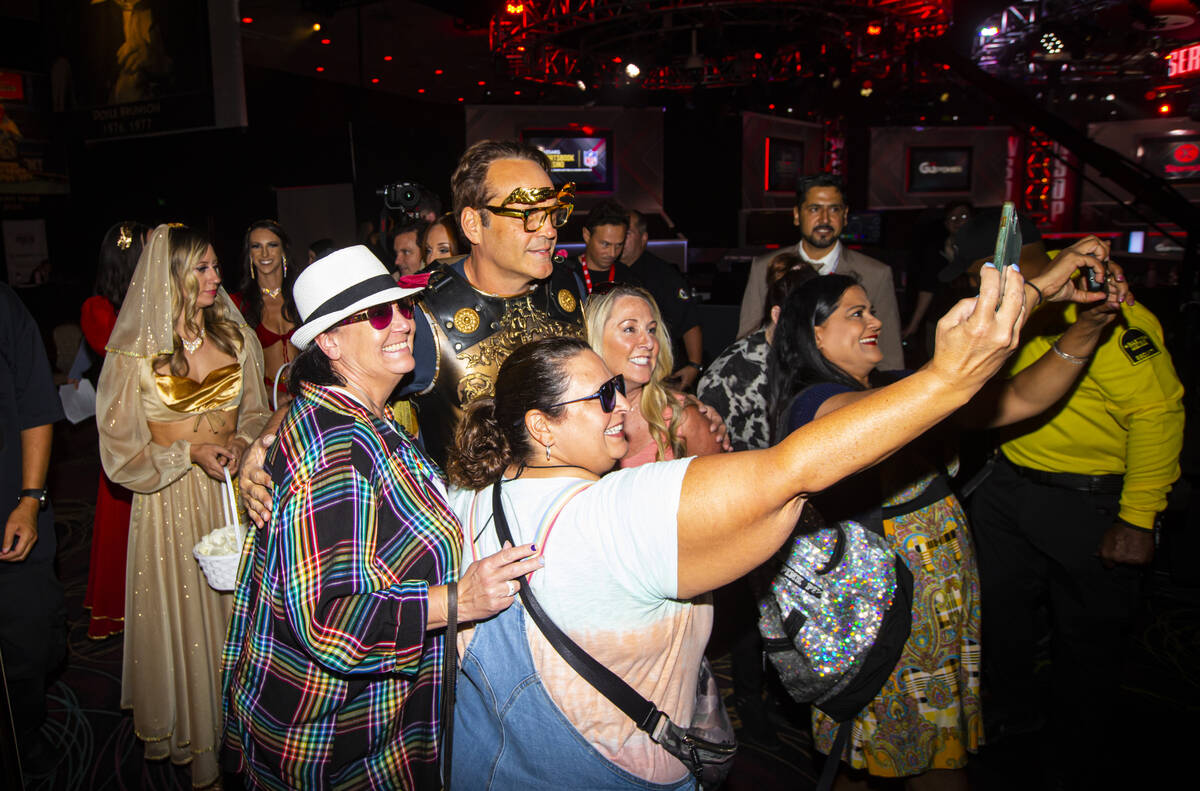 Actor and World Series of Poker master of ceremonies Vince Vaughn poses with fans during the WS ...