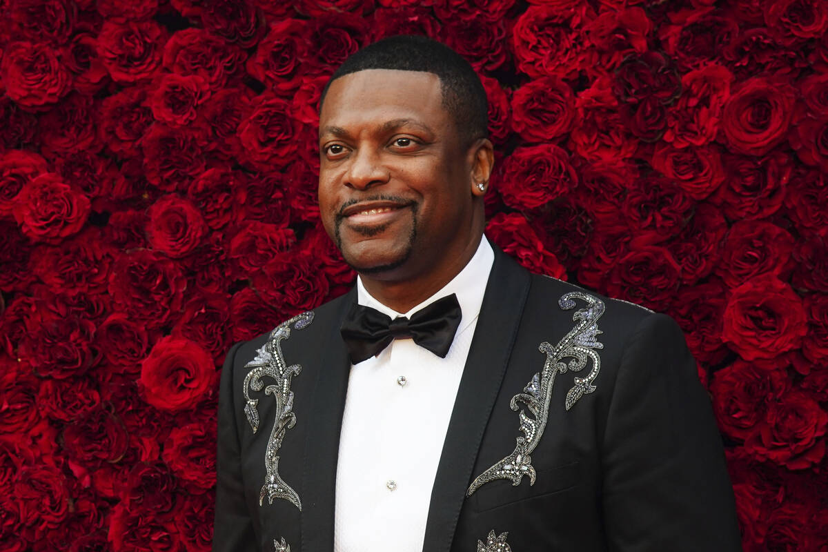 Chris Tucker poses for a photo on the red carpet at the grand opening of Tyler Perry Studios on ...