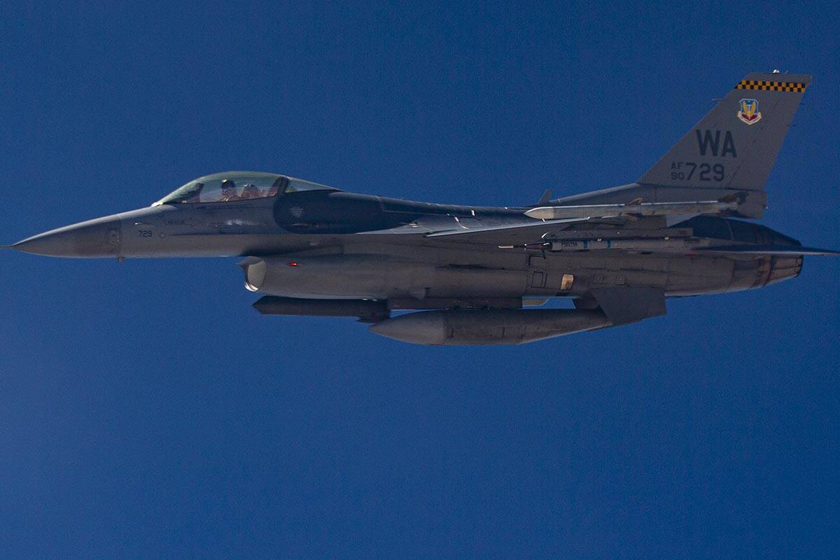 An F-16 flies alongside a KC-135 Stratotanker as it refuels planes around the Nevada Test and T ...