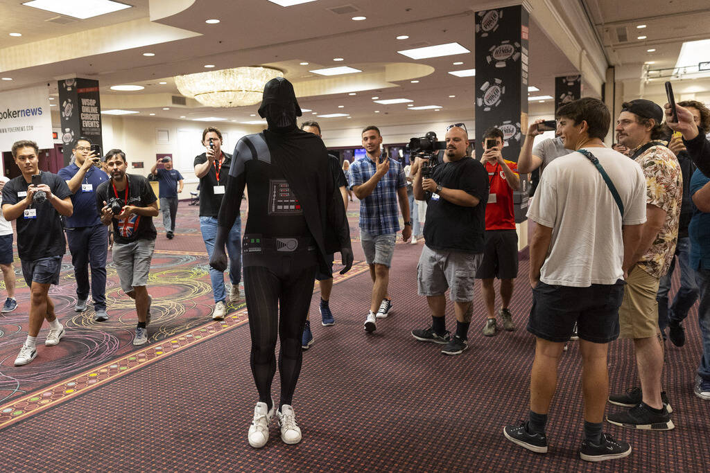 Phil Hellmuth makes his grand entrance to the World Series of Poker tournament dressed in a Dar ...