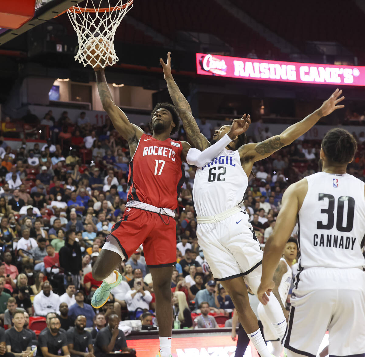 Houston Rockets' Tari Eason (17) lays up the ball against Orlando Magic's Emanuel Terry (62) du ...