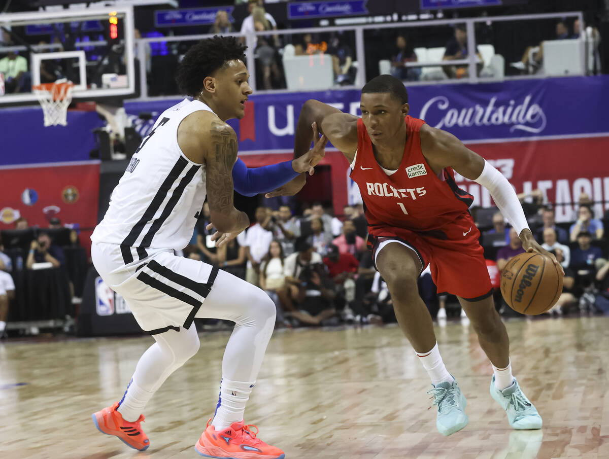 Houston Rockets' Jabari Smith (1) drives to the basket against Orlando Magic's Paolo Banchero d ...