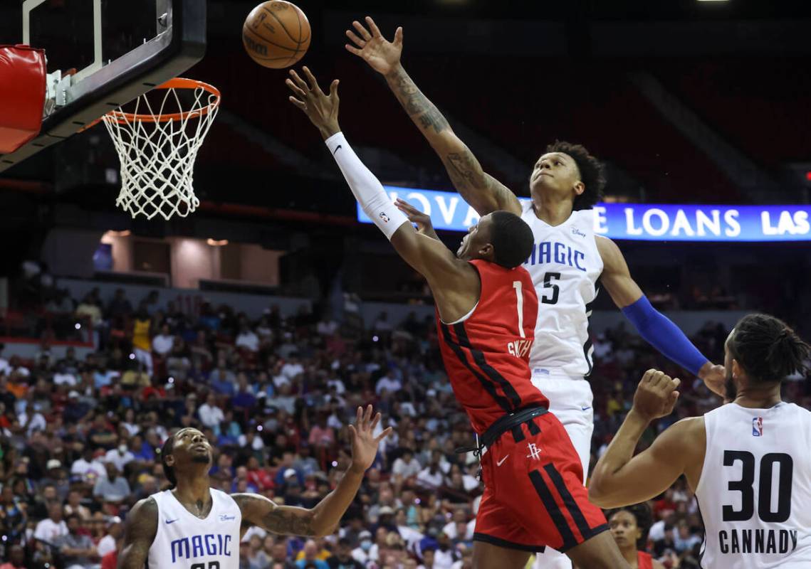 Houston Rockets' Jabari Smith (1) lays up the ball against Orlando Magic's Paolo Banchero (5) d ...