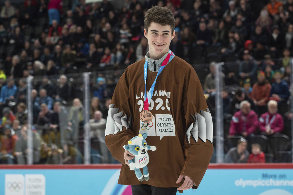Czech hockey player Matyas Sapovaliv receives the bronze medal after the ice hockey men's mixed ...