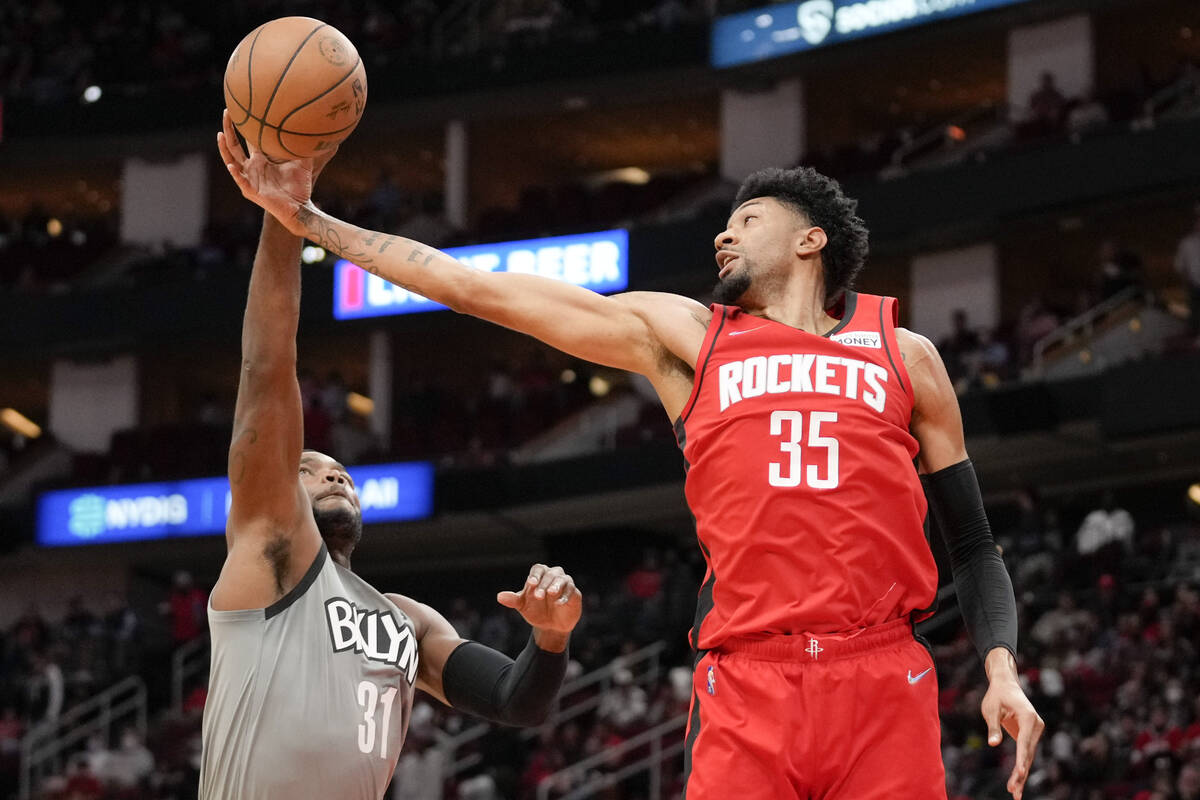 Houston Rockets center Christian Wood (35) and Brooklyn Nets forward Paul Millsap go for a rebo ...