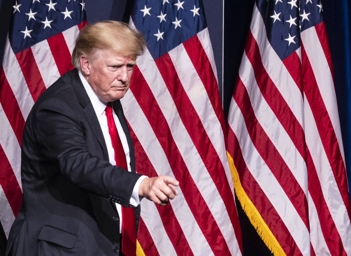 Former President Donald Trump points toward the crowd as he leaves the podium after campaigning ...