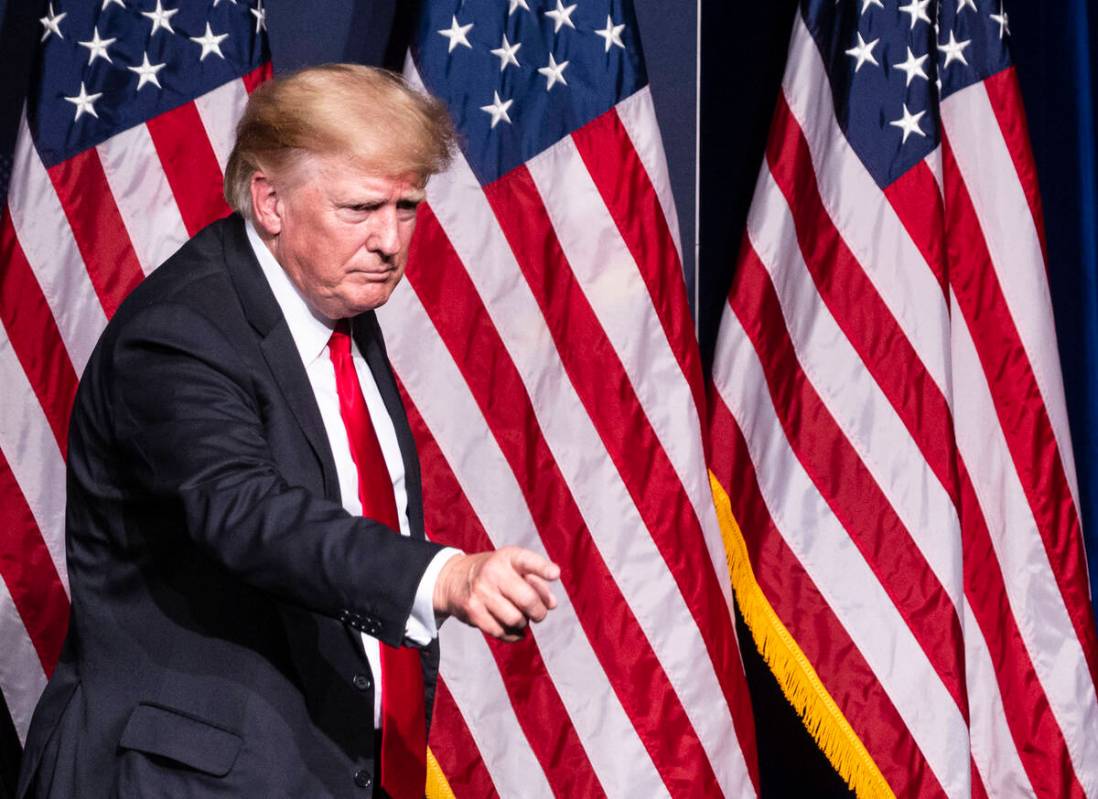 Former President Donald Trump points toward the crowd as he leaves the podium after campaigning ...