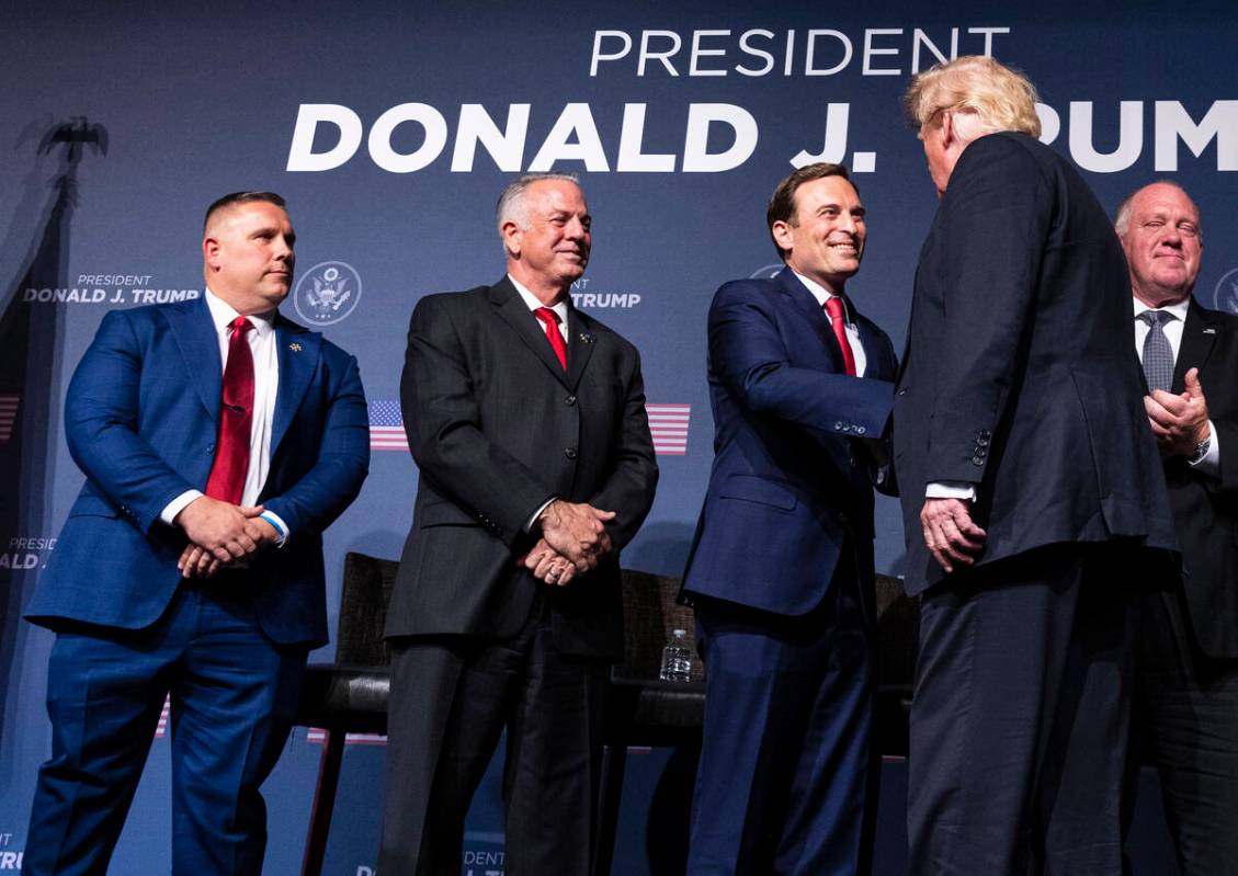 Former President Donald Trump, right, shakes hand with former Nevada Attorney General Adam Laxa ...