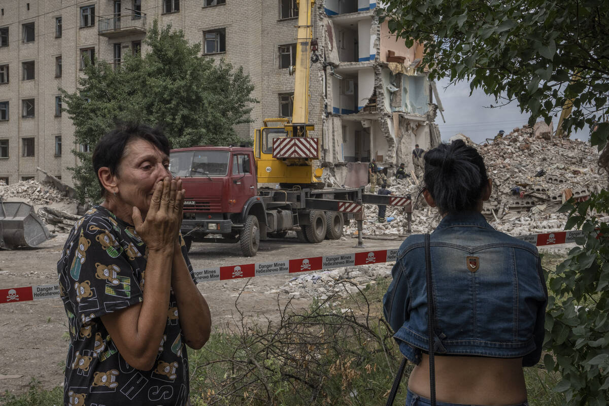 Iryna Shulimova, 59, weeps at the scene in the after math of a Russian rocket that hit an apart ...