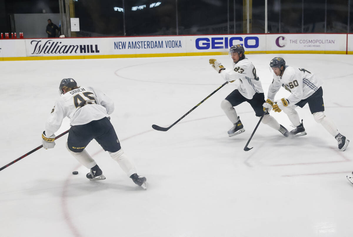 Golden Knights forward Carter Souch (45) skates with the puck ahead of forwards Daniel D&#x2019 ...