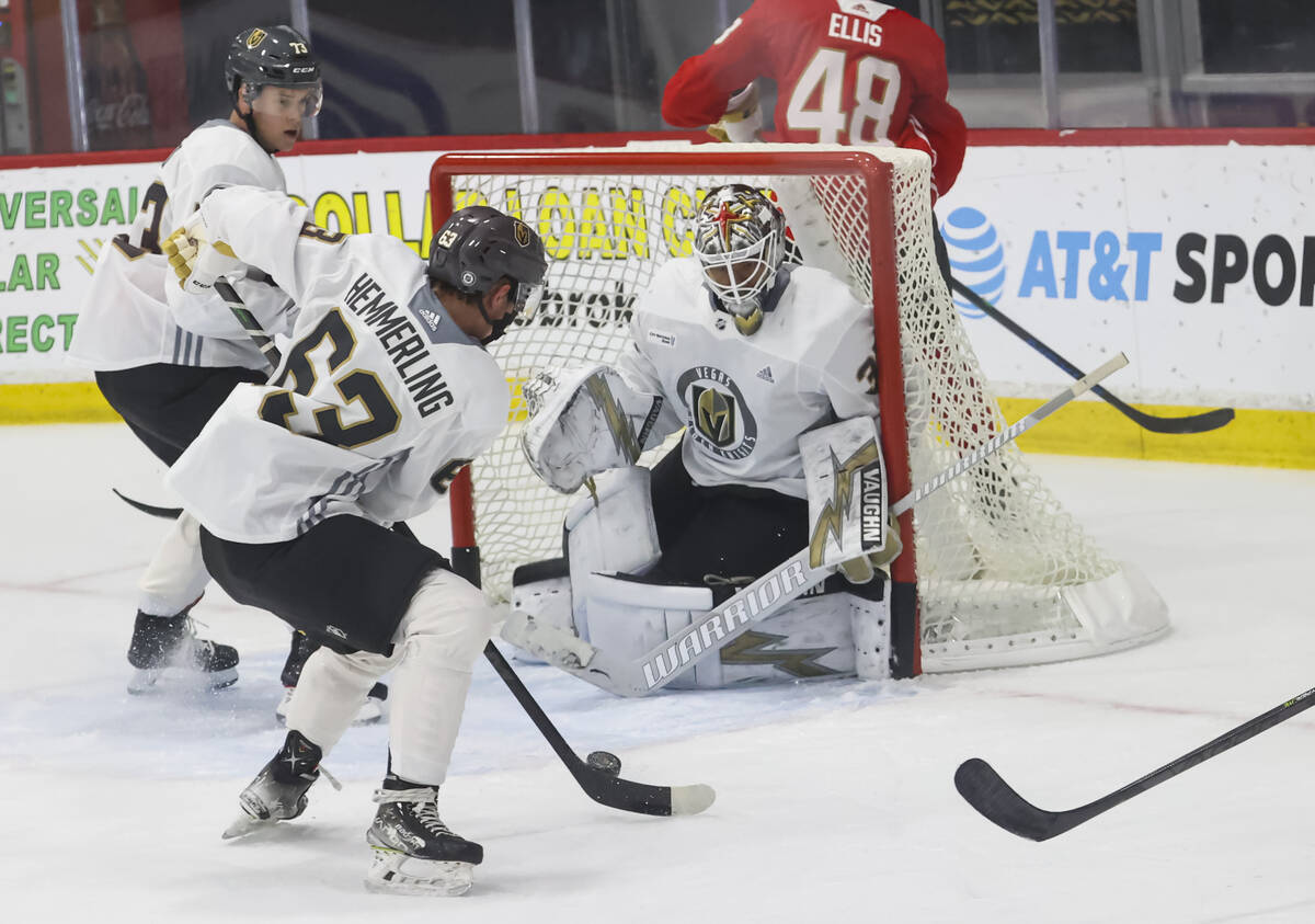 Golden Knights goaltender Isaiah Saville defends the net as forward Ben Hemmerling looks to sho ...