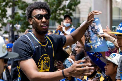Golden State Warriors' James Wiseman celebrates with fans during the NBA Championship parade in ...