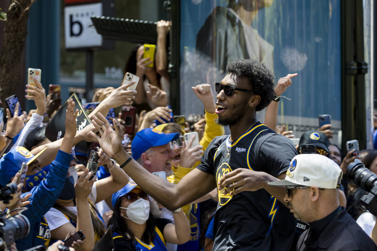 Golden State Warriors' James Wiseman celebrates with fans during the NBA Championship parade in ...