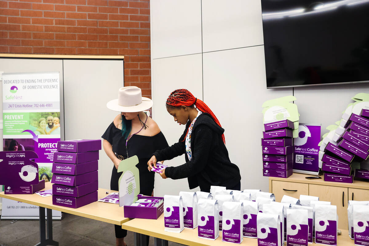 SafeNest Coffee consultant Joy Hoover, left, works with resident Tyresha, right, to pack boxes ...